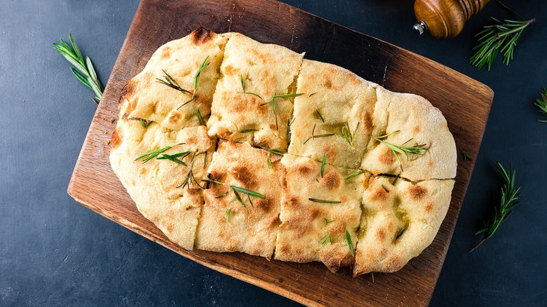 fresh baked focaccia bread on a cutting board