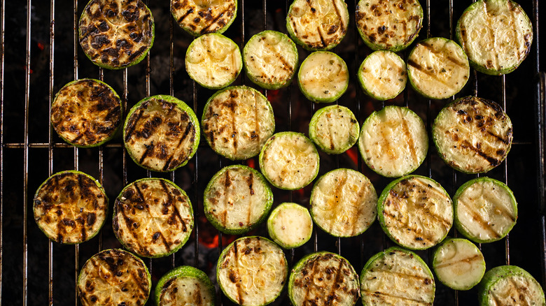 charred zucchini rounds on a grill