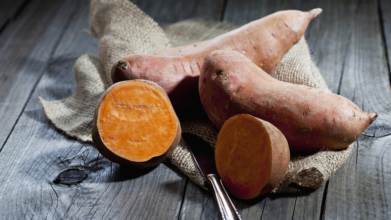 raw sweet potatoes with one cut open