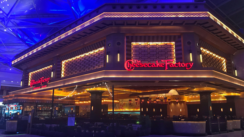 the exterior of a neon Cheesecake Factory