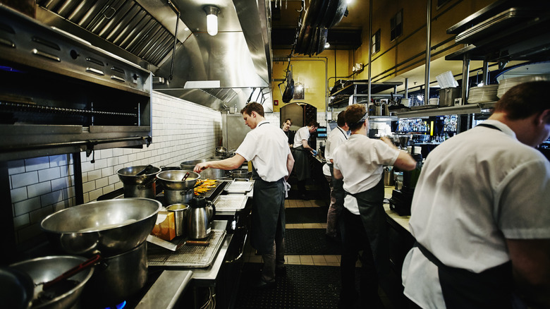 an image of restaurant staff working in a line kitchen