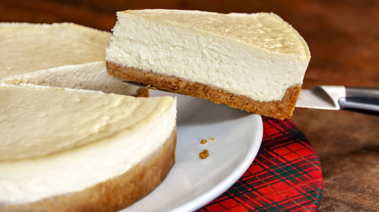 a slice of plain cheesecake lifted up by a fork