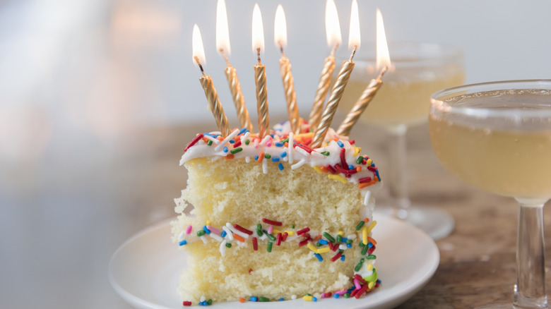 candles on top of a slice of birthday cake