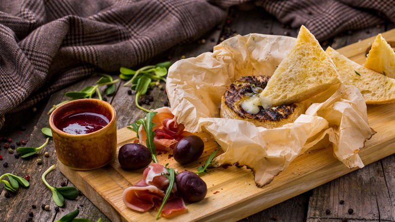 Ciabatta chip dipped in baked brie cheese