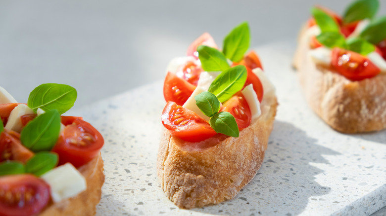 Ciabatta bruschetta with fresh tomatoes, bail, and mozzarella