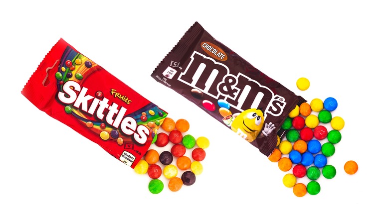 Open bags of Skittles and M&Ms