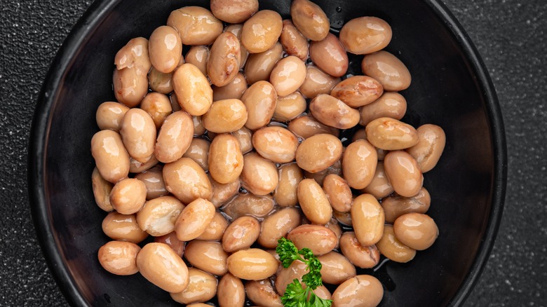 Boiled beans on black plate