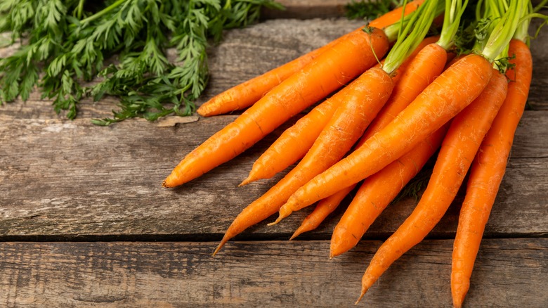 Baby carrots on wood board