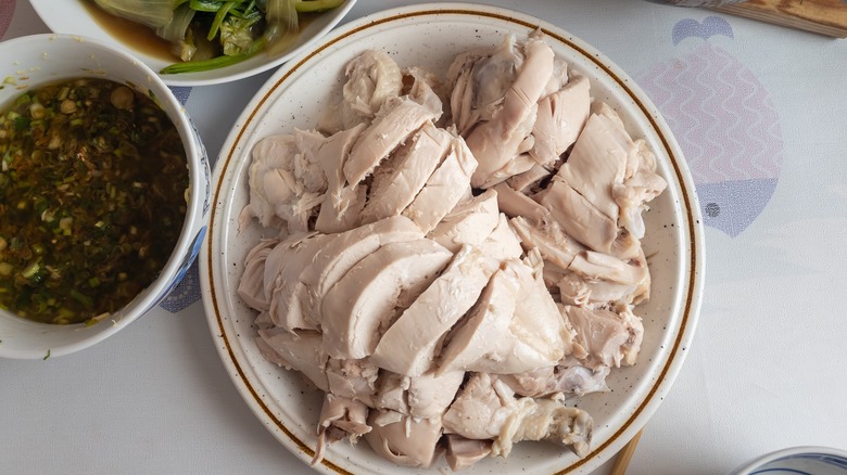 Poached chicken on white plate