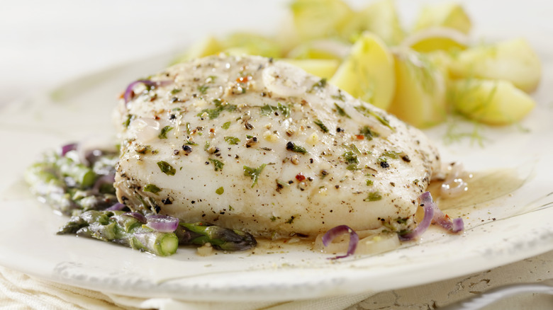 Poached fish on white plate