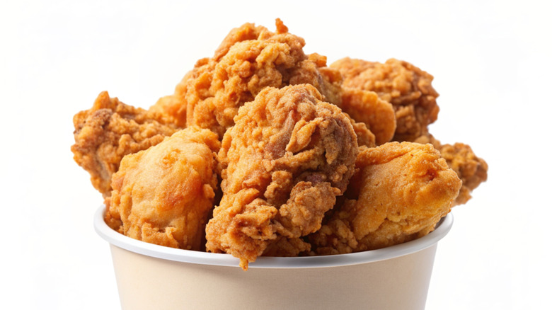 paper bucket of fried chicken pieces