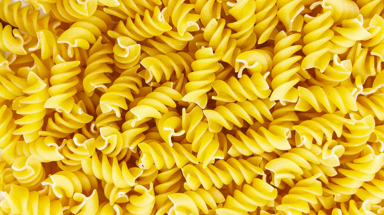 yellow spirals of dried rotini pasta