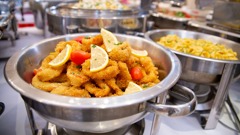 round metal dish filled with onion rings and lemon slices