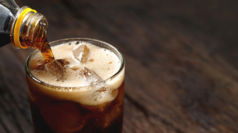 up close of soda being poured into glass