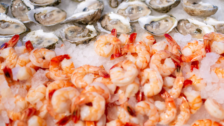 mix of oysters and shrimp on pile of crushed ice