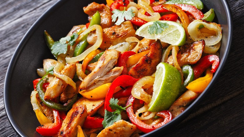 Chicken fajitas in black dish