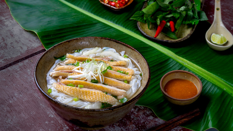 Chicken pho in brown bowl