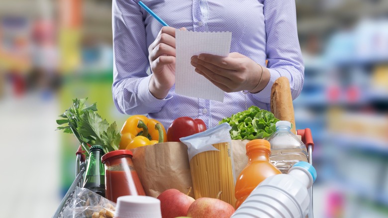 Person writing shopping list