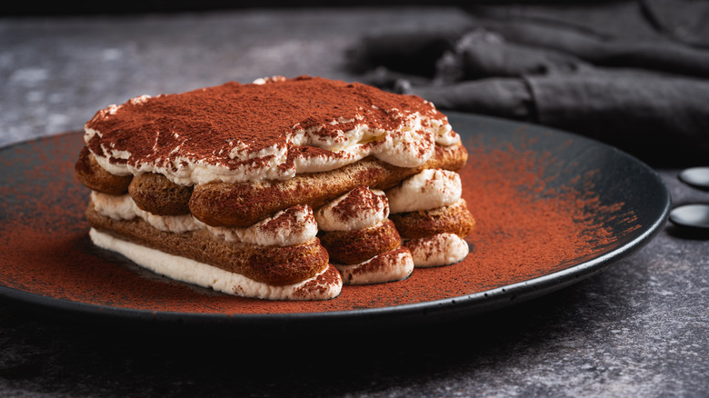 Tiramisu on a black plate