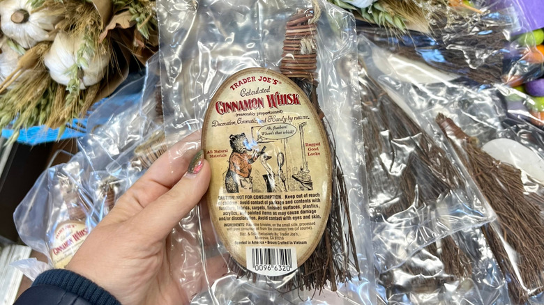 Hand holding Trader Joe's Cinnamon Whisk