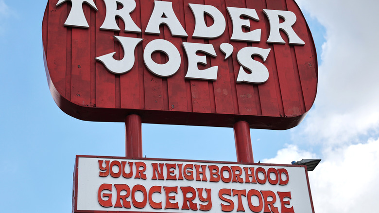 Old-style Trader Joe's sign with 'Your Neighborhood Grocery Store' sign beneath