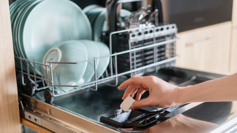 Putting detergent tab in dishwasher