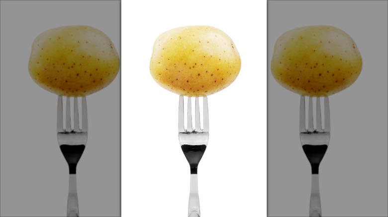 Raw potato on a fork