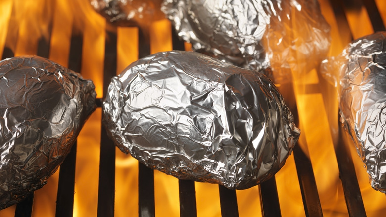 Foil-wrapped potatoes in the oven