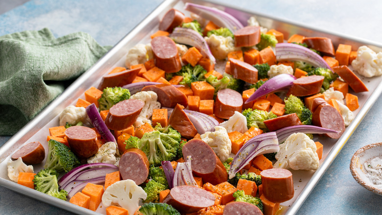 sheet pan with sweet potatoes, onions, sausage, and more