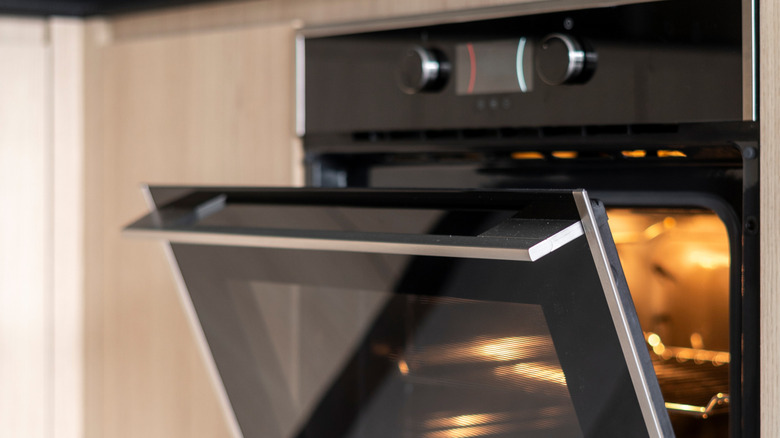 black oven with cracked door in kitchen