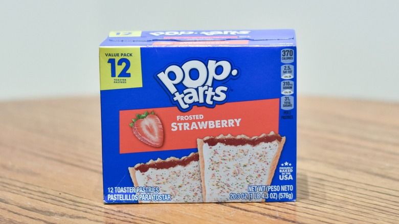 A box of Frosted Strawberry Pop Tarts on a wooden table