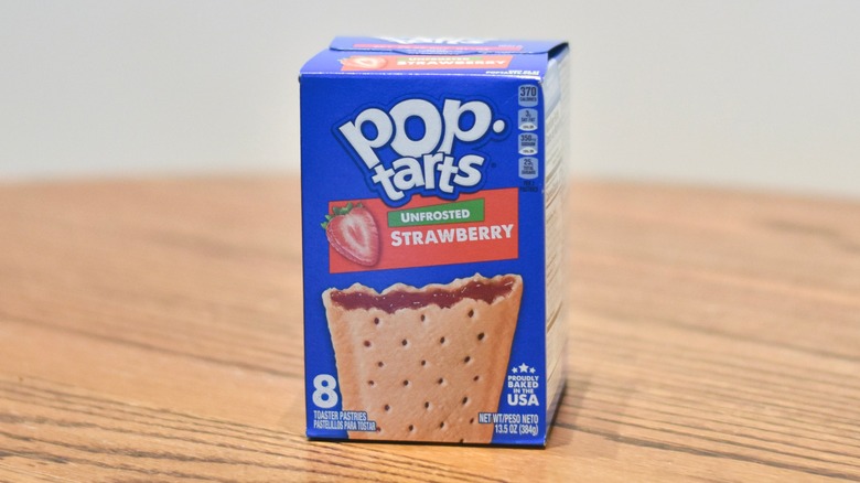 A box of Unfrosted Strawberry Pop Tarts on a wooden table