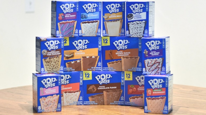 A collection of Pop-Tart boxes stacked on a wooden table