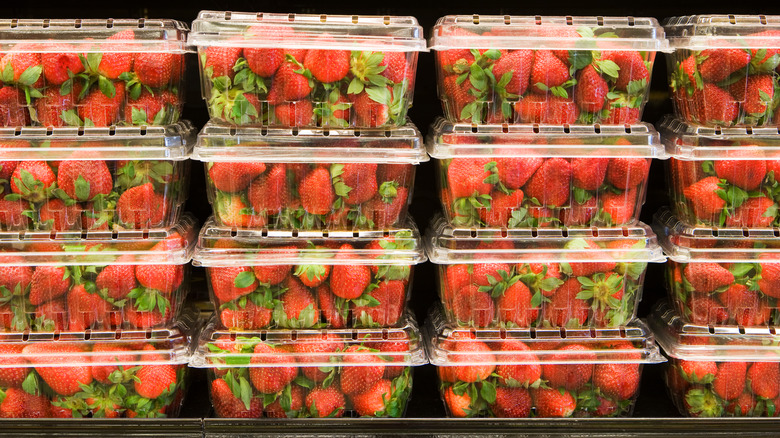 strawberries stacked in plastic containers