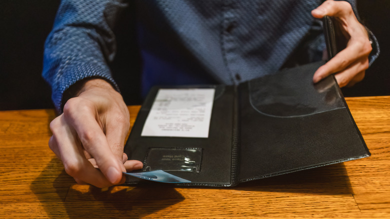 Person paying a restaurant bill