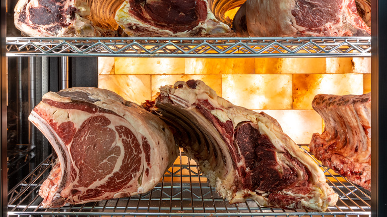 Steaks aging on racks