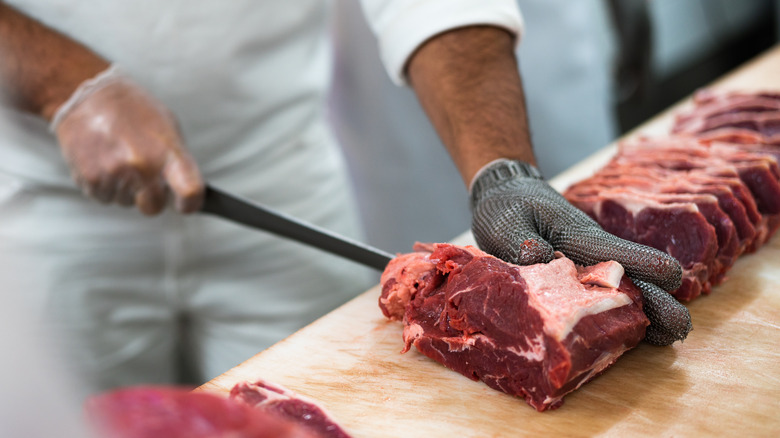 Butcher cutting steak