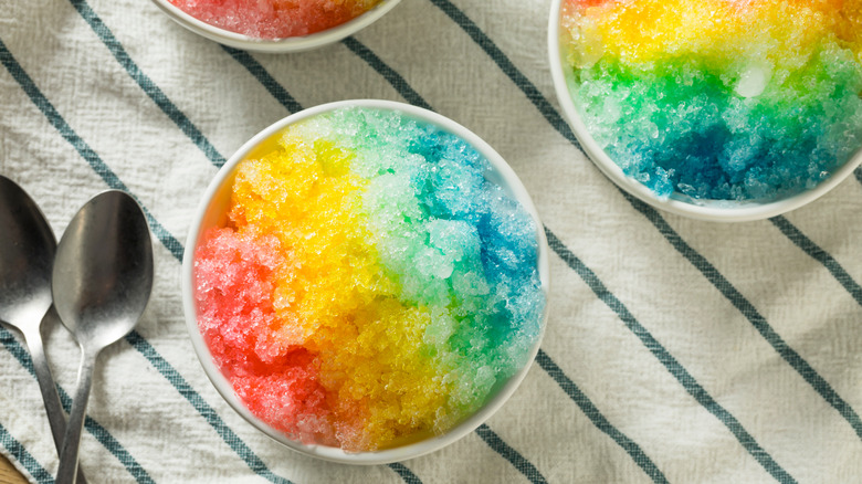 Brightly colored shaved ice and spoons