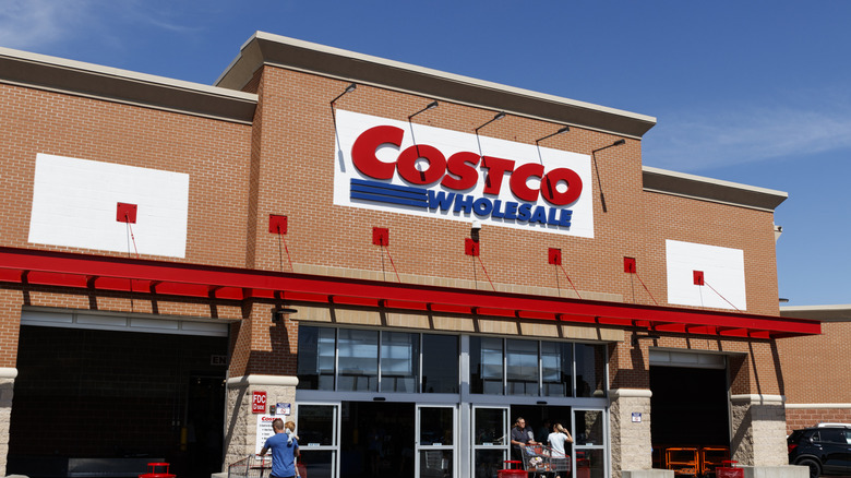 Shoppers going into Costco Wholesale with shopping carts