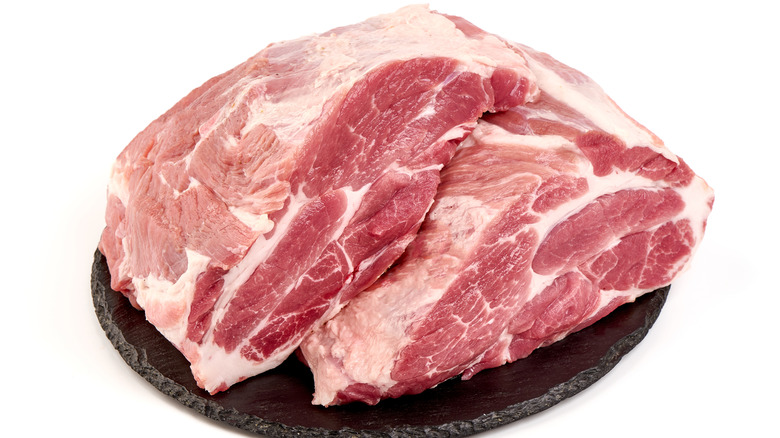 A raw pork shoulder with fat