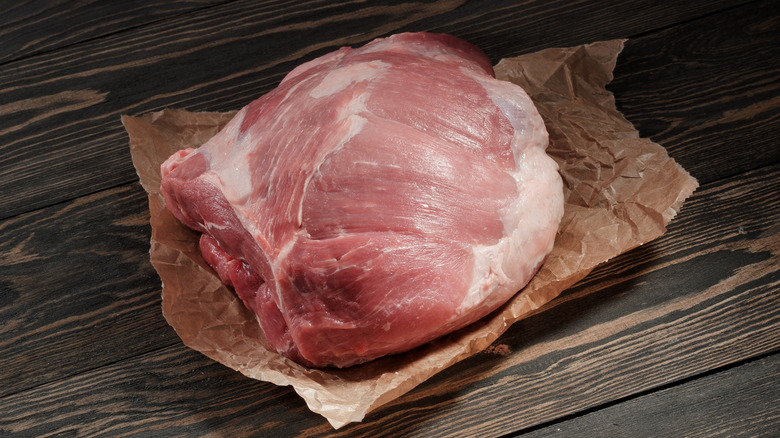 A raw pork shoulder on butcher paper