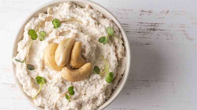 Vegan cashew cheese with whole cashews on top