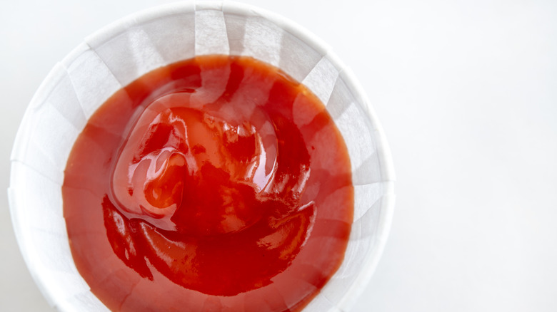 Paper cup filled with ketchup