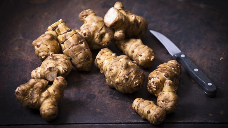 Sunchokes on a brown background are ready to prepare