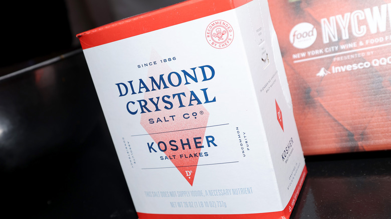 A box of Diamond crystal kosher salt flakes displayed on a black counter