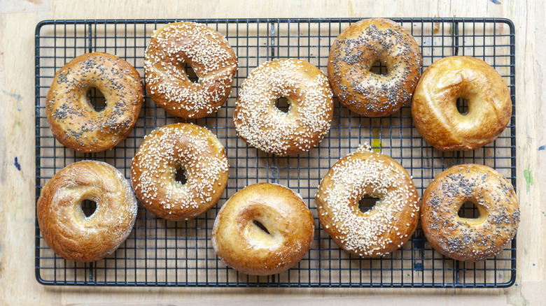 aerial picture of sesame and poppy seed bagels on a wire rack