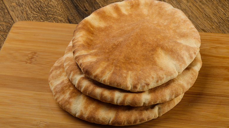 heap of pita breads on a wooden background