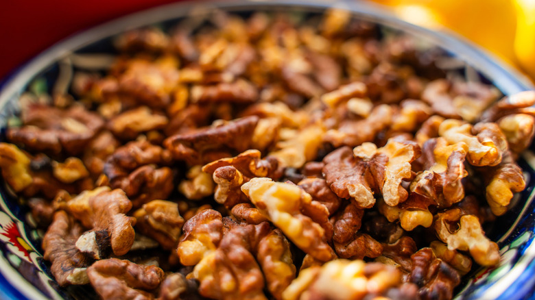 Close up of toasted walnuts in a bowl