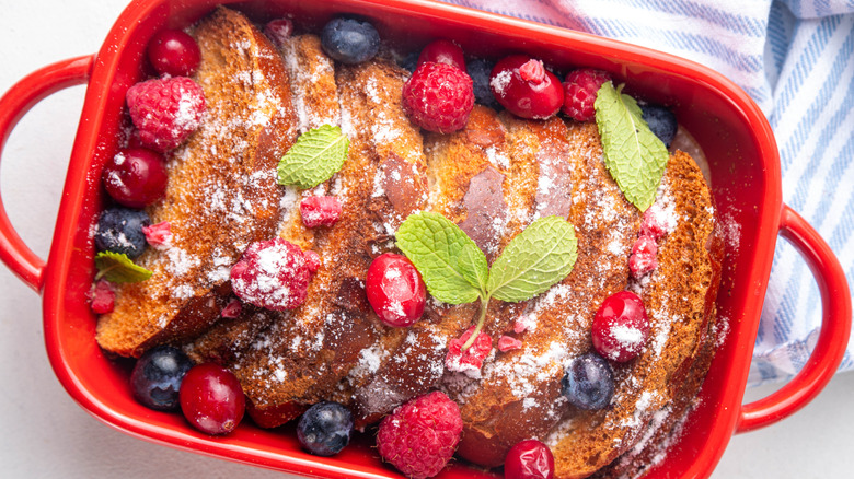 Tray of french toast with berries and powdered sugar