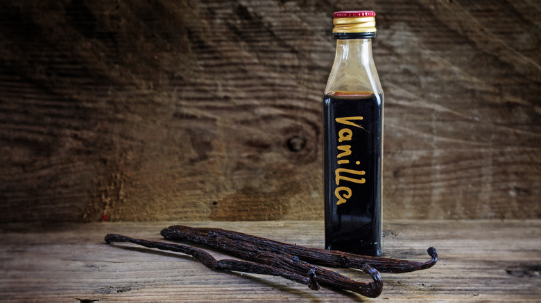 Vanilla pods with a bottle of vanilla extract